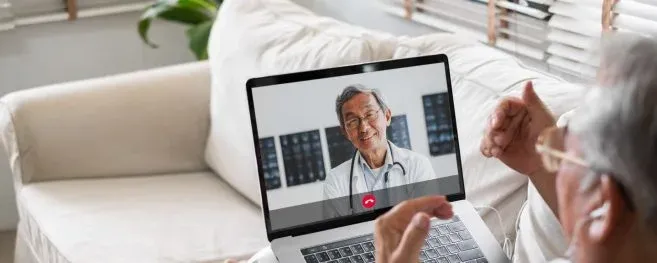 Patient Having a Virtual Consultation with Doctor on Laptop
