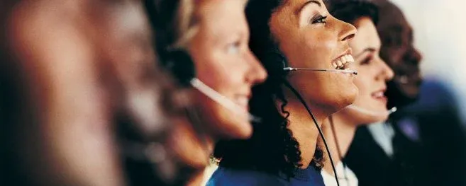 Group of Call Center Agents Smiling While Working
