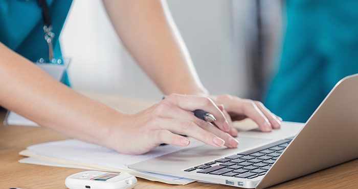 A Person Typing On A Computer