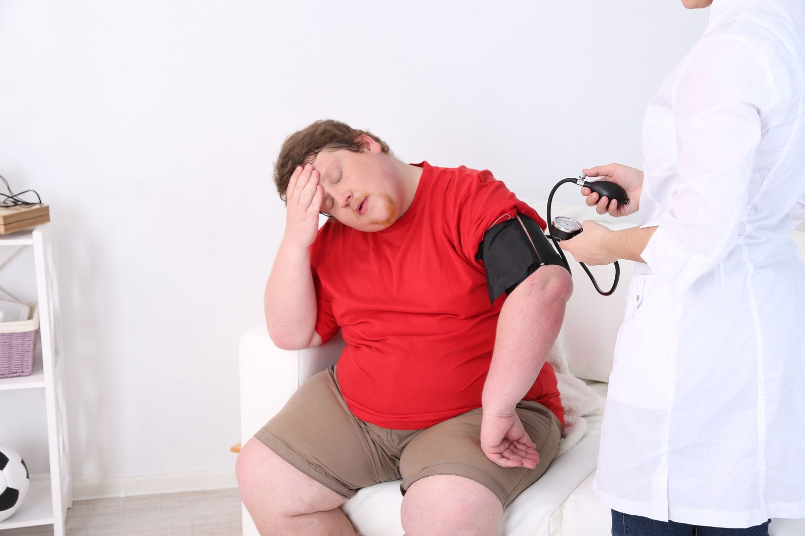 Doctor examining patient obesity on light background