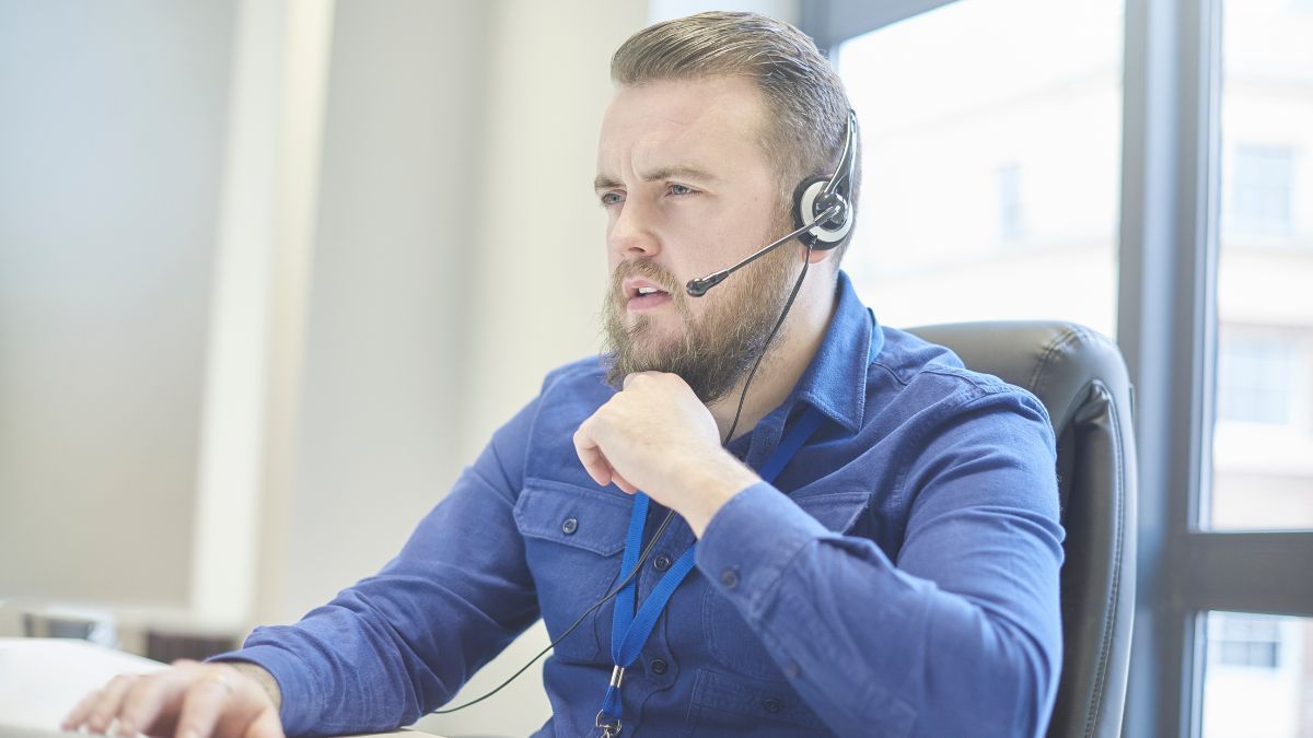 Man In Blue Shirt Talking On Phone