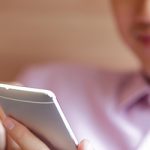 A Person Checking Patient Engagement Statistics on Phone A Person Checking Patient Engagement Statistics on Phone