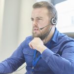 Man In Blue Shirt Talking On Phone