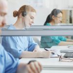 group-people-sitting-table-talking-clients-medical-call-center (1) 5 Important Healthcare Call Center Metrics