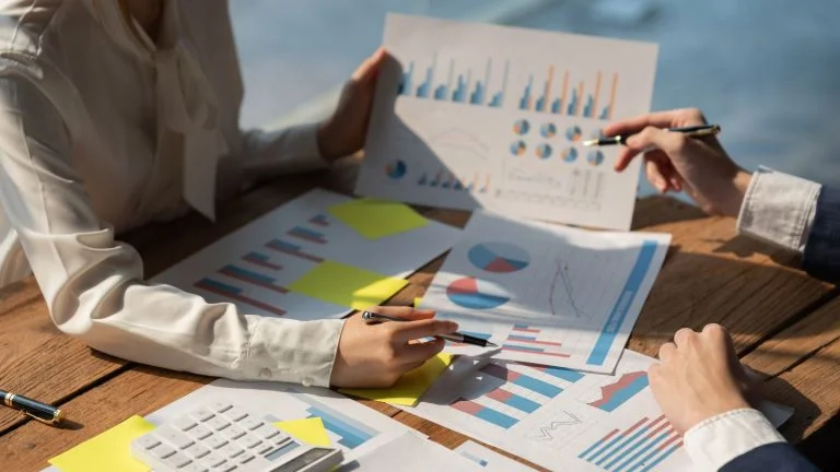 Business People Analyzing Graphs Charts And Data